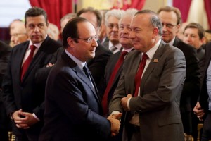 French President Hollande shakes hand with employer's body MEDEF union leader Gattaz at the Elysee Palace in Paris